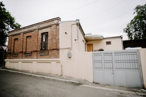 A two-story building with a brick facade and a beige upper section. - Viking Hostel (Tbilisi)