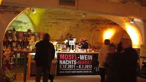 A market stall with a sign indicating it is the Mosel-Wein Nachtsmarkt, operating from 3.12.2011 to 8.1.2012.
