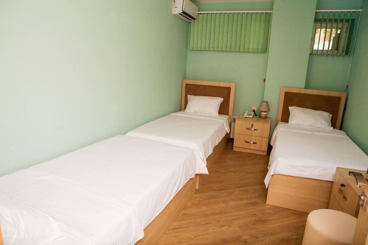 Basic Triple Room, Shared Bathroom | Minibar, in-room safe, desk, blackout drapes