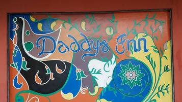 A colorful mural with the text "Daddy's Inn" and decorative elements.