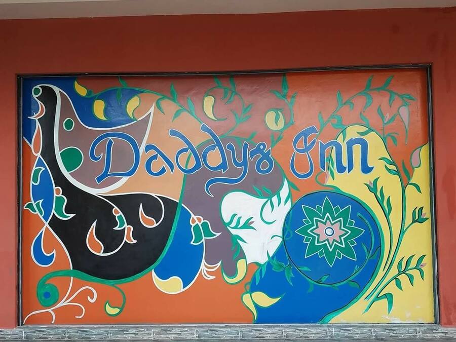 A colorful mural with the text "Daddy's Inn" and decorative elements.
