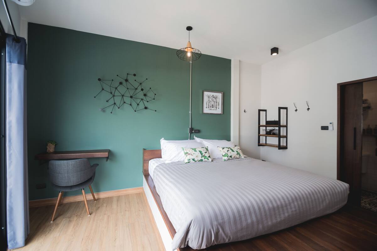 Premium bedding, desk, laptop workspace, blackout drapes