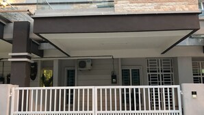 A two-story house with a flat roof, a balcony, and a gated entrance. - Langkawi Shell Out Villa (Langkawi)