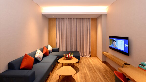 A modern living room with a sofa, coffee table, and TV.