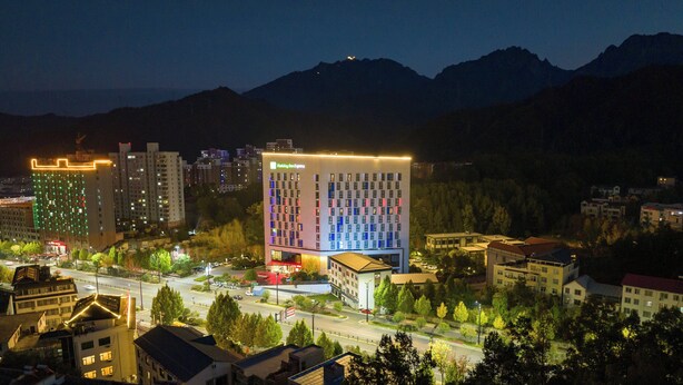 A hotel with a modern design, multiple floors, and a prominent sign. - Holiday Inn Express Luanchuan by IHG (Luoyang)