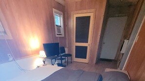 A bedroom with a bed, a chair, a desk, and a window. - Kayak Shak - Downtown Wetumpka (Wetumpka)