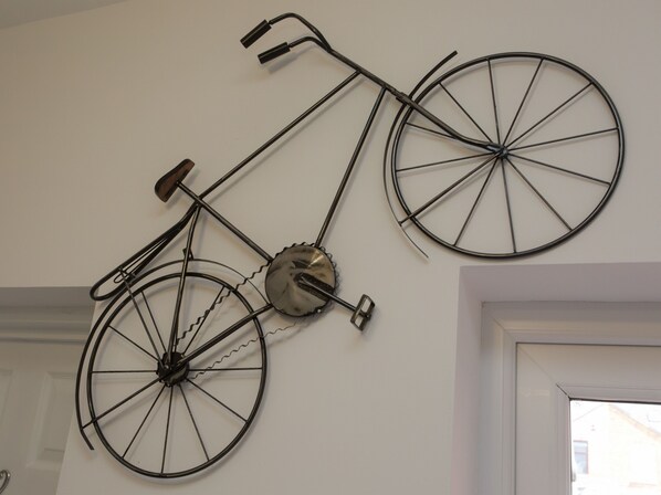 A wall-mounted bicycle sculpture. - Crewe Rooms Westminster Street (Crewe)