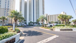 A multi-story hotel with a central courtyard, palm trees, and a sign reading "PALACIO." - 2000sqft Beachfront Beauty on Perdido Key.  (Pensacola)