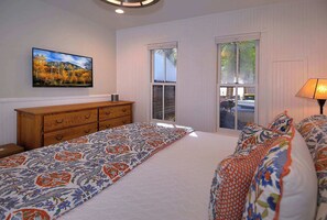 A bedroom with a bed, dresser, and a painting on the wall. - Historic Elk Ave Haven, Hot tub, Town of CB. (Crested Butte)