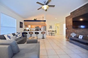 Relax in this inviting space with a comfortable sofa, flat-screen TV, and central island for dining and socializing.