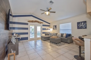 Relax in a stylish living room with a grey sectional sofa, flat-screen TV, and wooden coffee table.