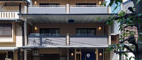 A two-story building with a traditional Japanese architectural style, featuring a wooden facade and a tiled roof.