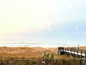 A beach view with a wooden boardwalk and a fence. - 1st Floor Amelia South's Oceanfront Crown Jewel   (Fernandina Beach)