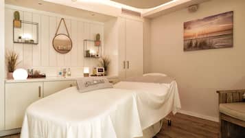 Relax in a serene bedroom with a large bed, a cozy seating area, and a wardrobe.