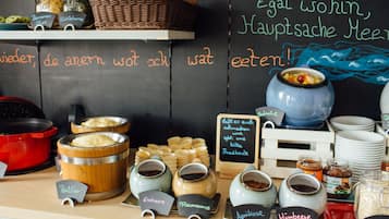 A breakfast buffet with various food items and condiments.