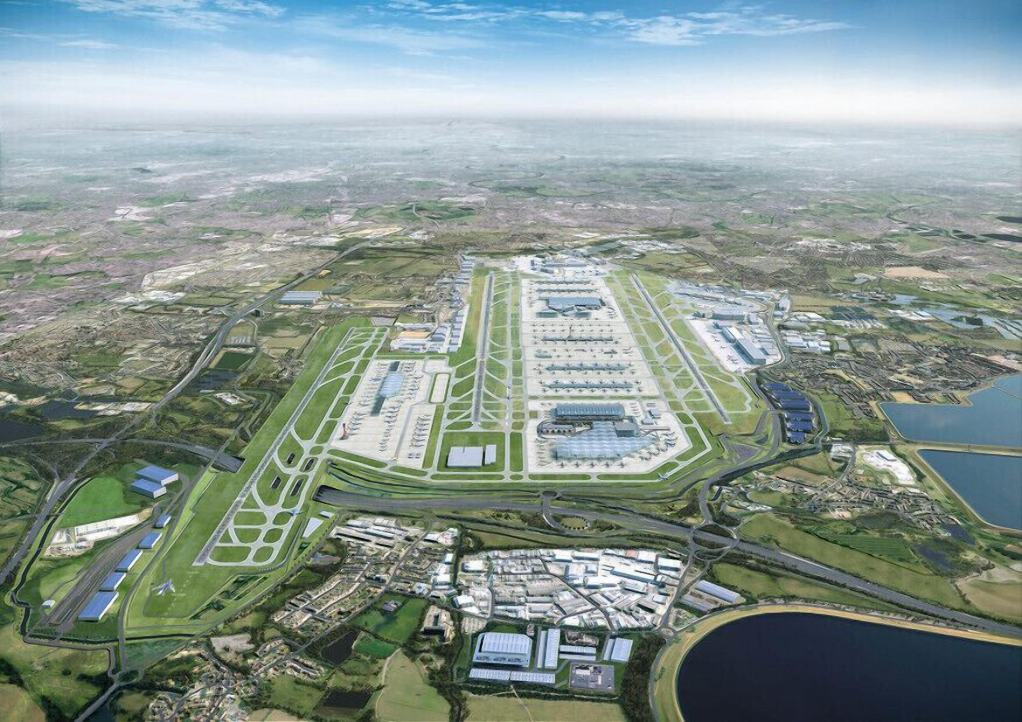 An aerial view of an airport with multiple runways, taxiways, and terminal buildings.