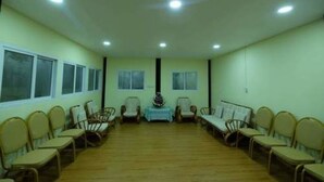 A conference room with a long table, chairs, and a floral centerpiece.