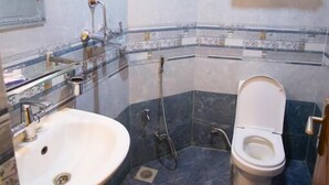 A modern bathroom with a sink, toilet, and shower. - Hotel Rosemary Homes (Kathmandu)