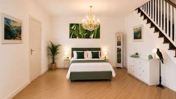 A bedroom with a bed, a chandelier, a staircase, and a parrot.