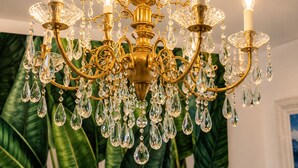 A chandelier with multiple arms and crystal decorations.
