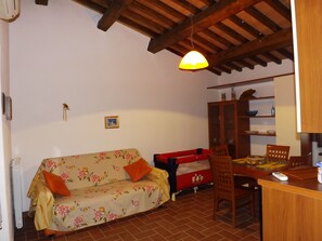 Departamento, 1 habitación | Área de sala de estar | Televisión de pantalla plana