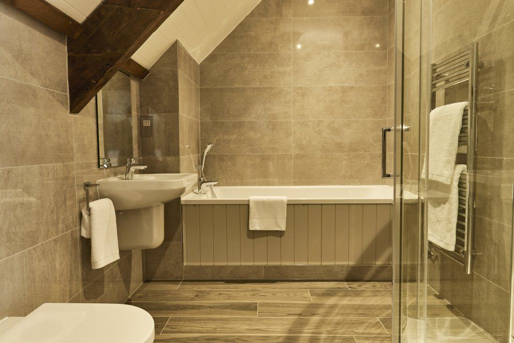 A modern bathroom with a freestanding bathtub, a sink, and a toilet.