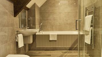A modern bathroom with a freestanding bathtub, a sink, and a toilet.
