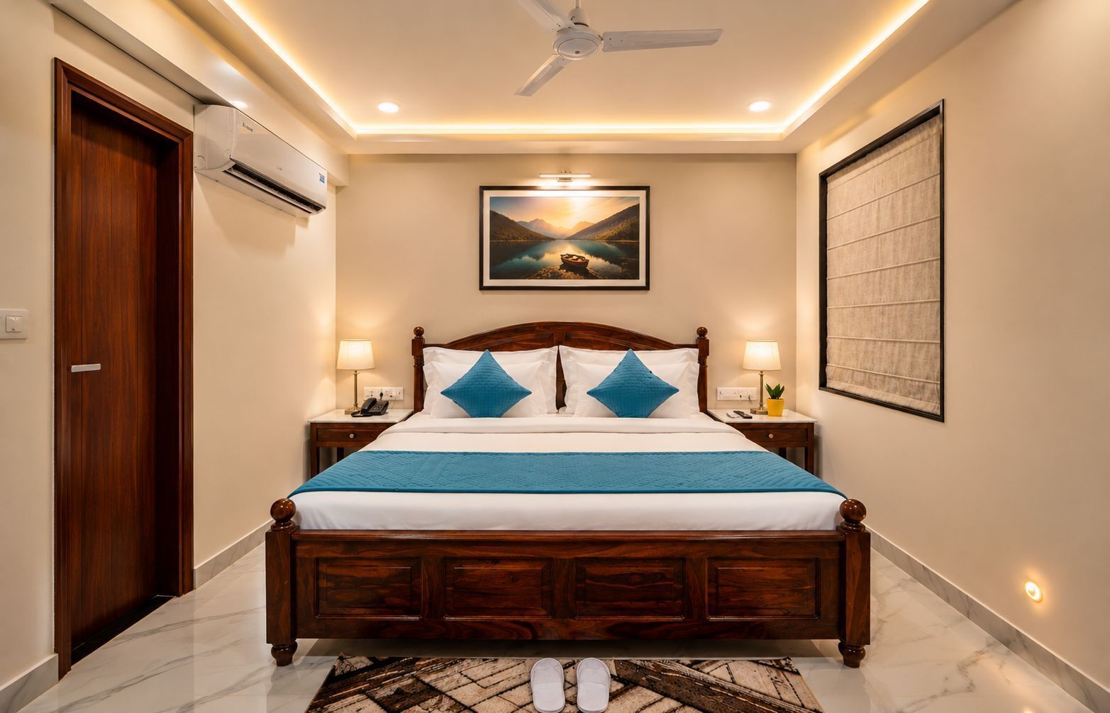 A bedroom with a wooden bed, two bedside tables with lamps, a ceiling fan, an air conditioning unit, a framed landscape painting, and a marble floor.