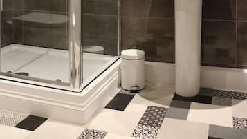 Separate tub and shower, free toiletries, hair dryer, heated floors