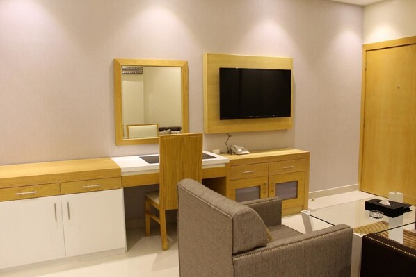 A modern bathroom with a vanity, mirror, and a mounted television. - AL Muhaidb Residence Abha - Economic (Abha)