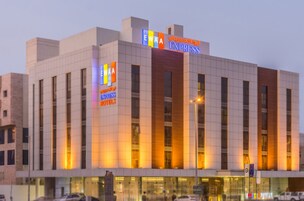 A hotel with a modern design, featuring a prominent 'EWA EXPRESS HOTELS' sign.
