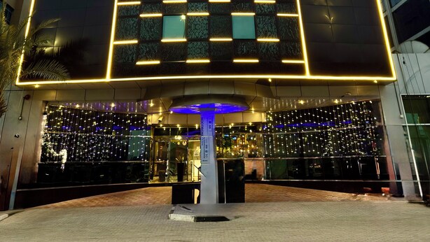 A modern hotel with a prominent sign reading "SMANA HOTEL". - Smana Hotel Al Raffa (Dubai)