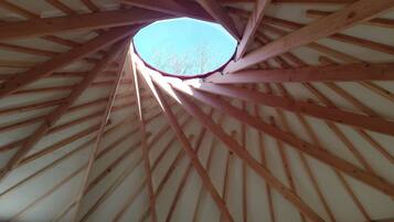 A wooden ceiling structure with a skylight.