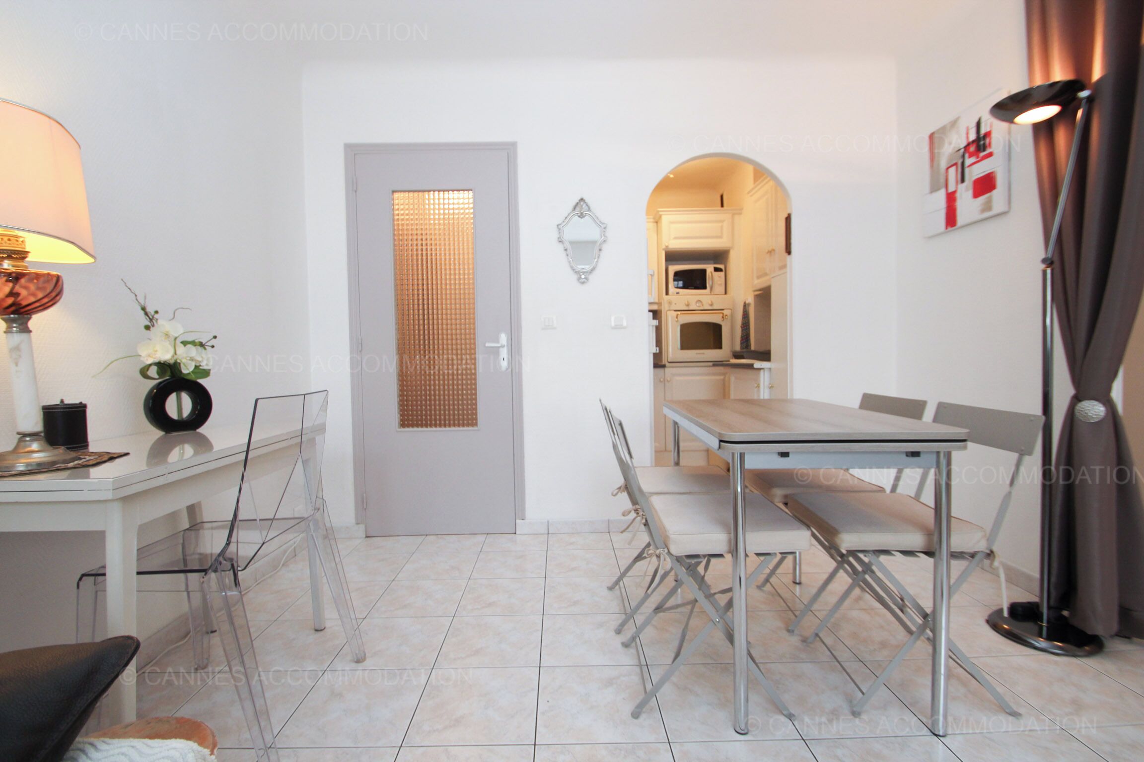 A modern kitchen with white cabinets, a microwave, and an oven.