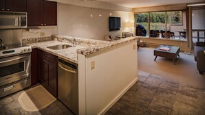 A modern kitchen with granite countertops, stainless steel appliances, and a large island. - Deluxe Unit with Unbeatable Deck Views (Telluride)