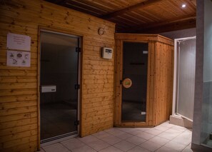 A wooden cabin with two glass doors, one labeled "TOILET" and another with a sign advising to "put on red shoes." - La Fleche D'or (Chatel)