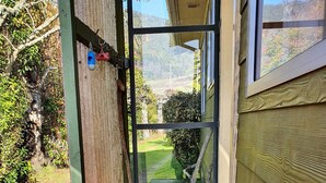 A wooden staircase leading to a house with a view of a garden and hills. - Ngakuta Bay, Marlborough Sounds. (Ngakuta Bay)