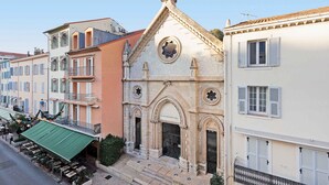 A church with a prominent cross, arched windows, and a bell tower. - Cruise-1997-We love this studio! (Cannes)