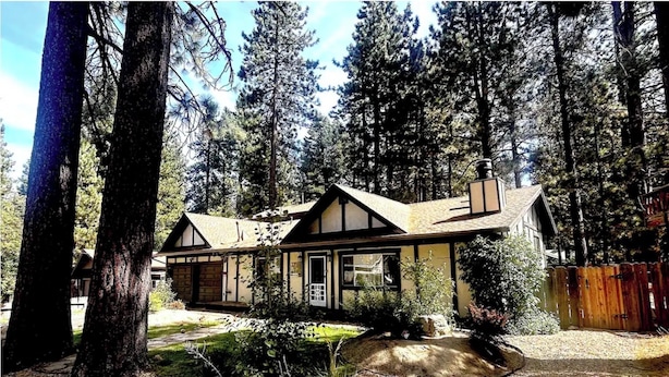 A cabin with a gabled roof, surrounded by tall trees. - Tahoe Delight: 5BR, Hot Tub, Sauna, Pool Table & Big Yard ! Close to beach  (South Lake Tahoe)