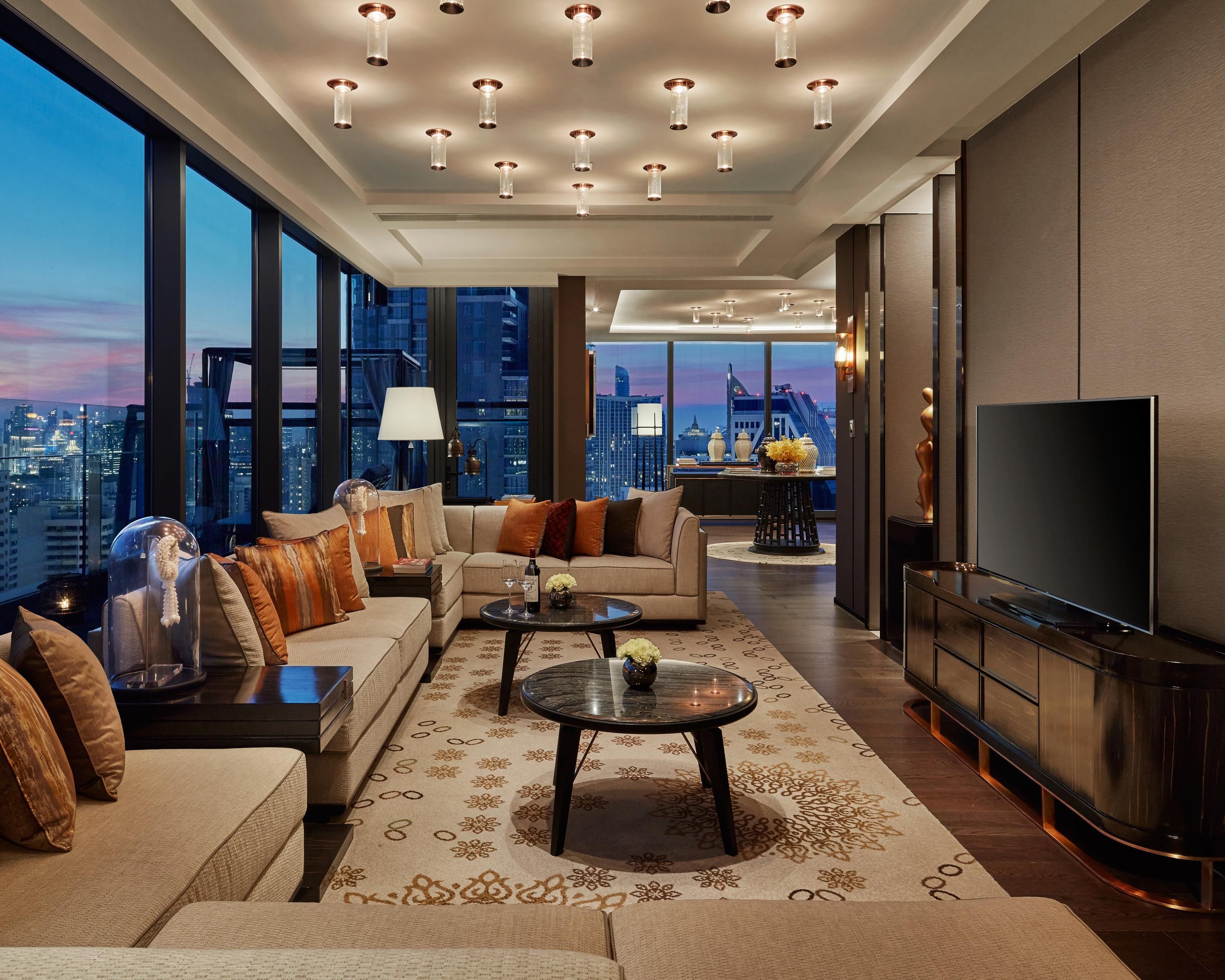 A modern living room with a sofa set, coffee table, and a television.