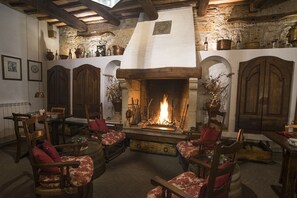 Una habitación acogedora con chimenea, muebles de madera y paredes de piedra.