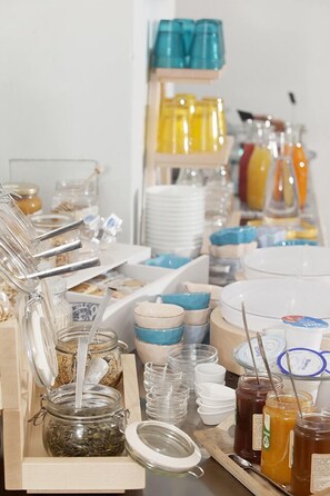 A buffet setup with various food items and serving utensils.