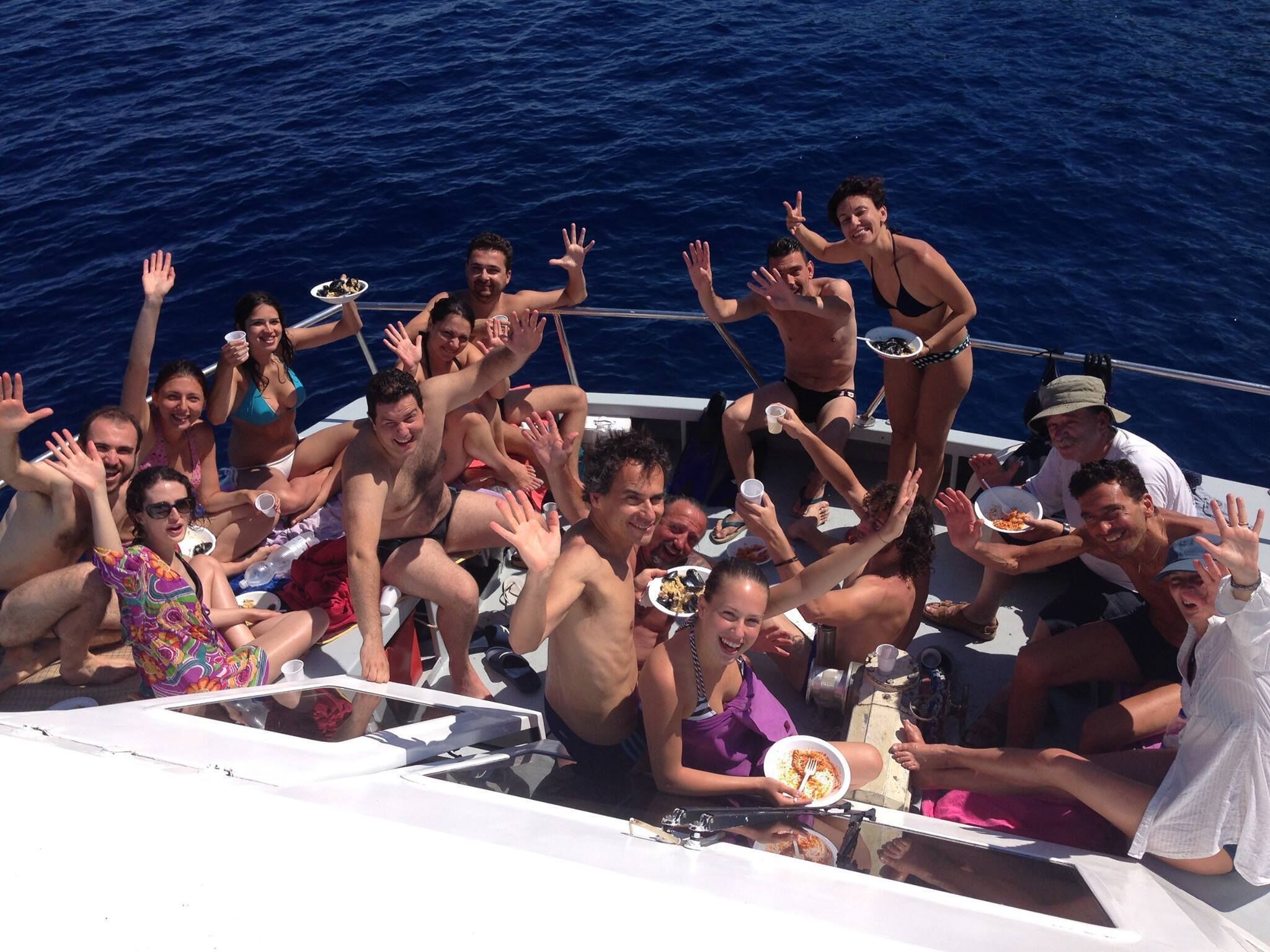 A group of people on a boat with a view of the ocean.
