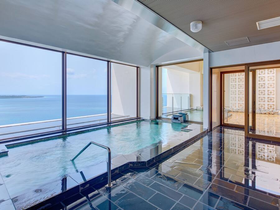 A spacious indoor pool with clear views of the sea, large windows, and a modern design.
