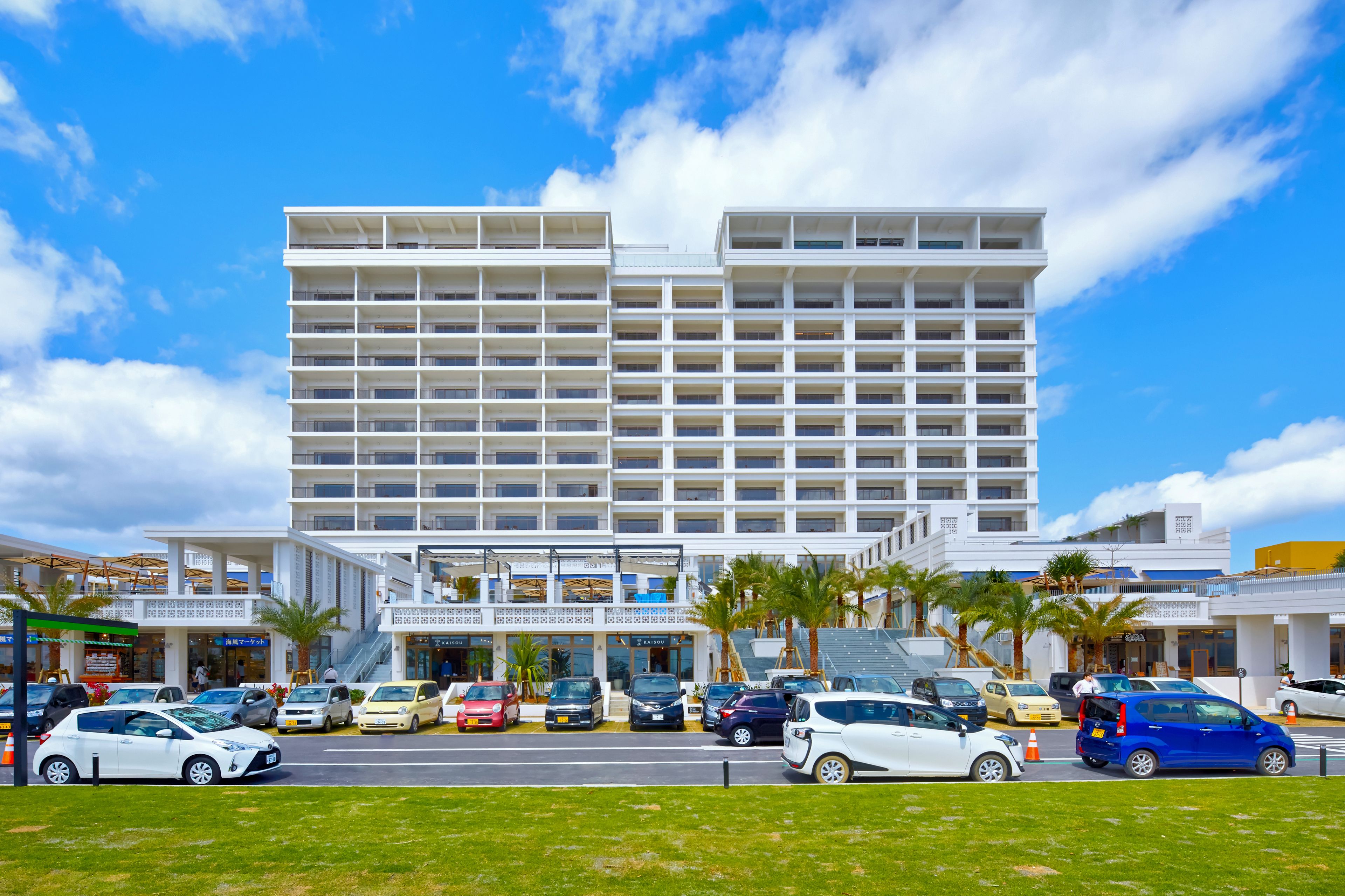 A multi-story hotel with a modern design, featuring a central atrium and multiple balconies.