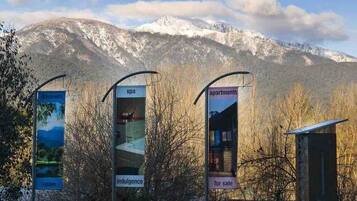 A mountain backdrop with signs for 'Dreamers,' 'Spa,' 'Indulgence,' and 'Apartments for sale.'