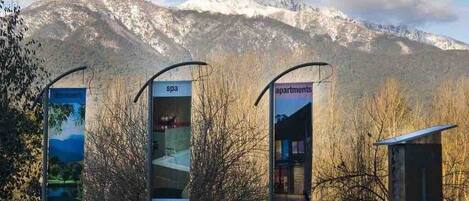 A mountain backdrop with signs for 'Dreamers,' 'Spa,' 'Indulgence,' and 'Apartments for sale.'