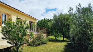 A yellow building with a tiled roof, surrounded by a well-maintained lawn and trees. - PROMOTION for May 26 MAY 1 JUNE (Saint-Florent)