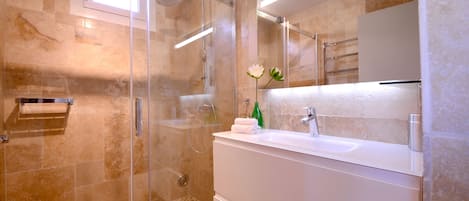 Shower, hair dryer, towels, toilet paper