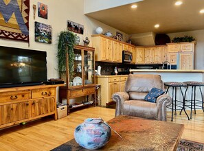 Relax in a well-appointed living room with a comfortable seating area, flat-screen TV, and dining table.